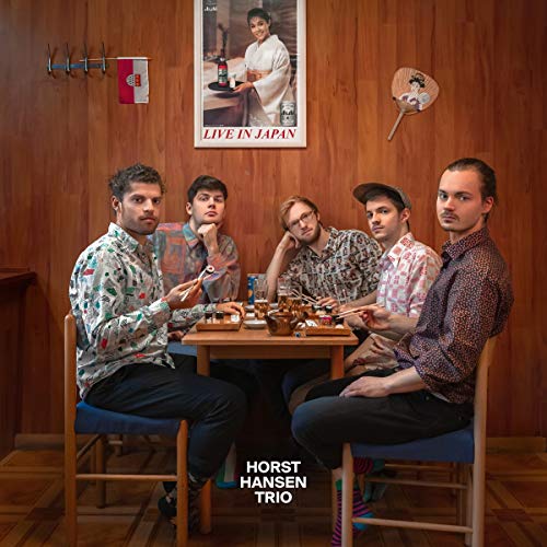 Five men seated around a table in a wood-paneled room.