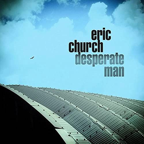 Eric Church's "Desperate Man" album cover with a blue sky and roofline.