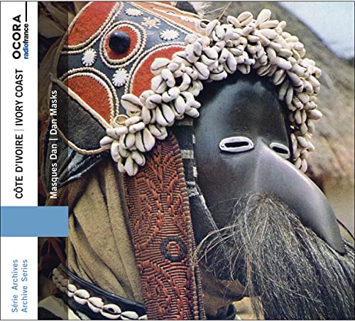 Ivory Coast Dan mask covered in cowrie shells, close-up view.