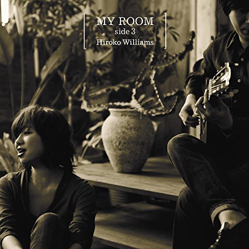 CD cover featuring two people with a guitar in a room.
