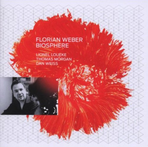 "Album cover with red paint splatter, white text, and a small black-and-white portrait."