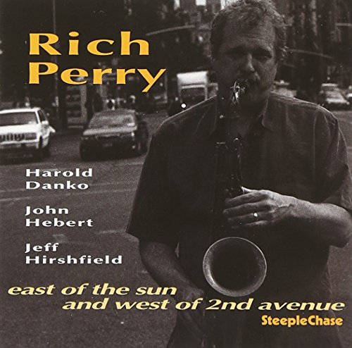Black and white CD cover with man playing saxophone on a city street.