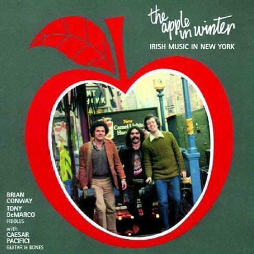"Album cover with red apple shape and three men inside on a green background."