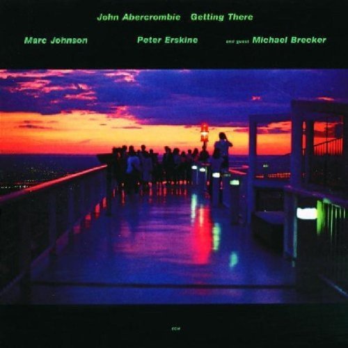"CD cover with people on a viewing platform at sunset, names listed above."