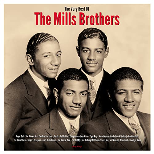 Vintage sepia-toned portrait of the four Mills Brothers members in suits.