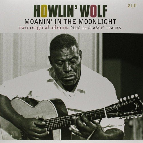 "Black and white image of a man playing guitar on a vinyl album cover."