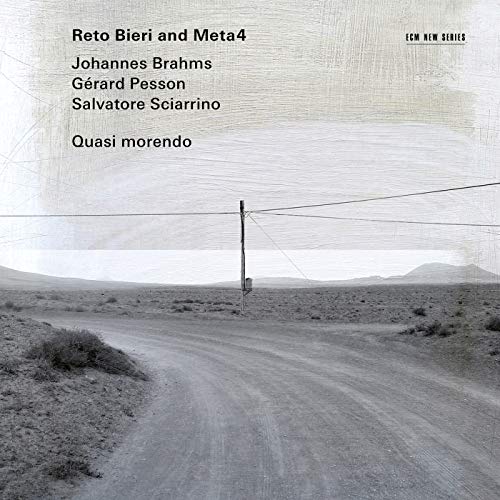 A CD cover with a desert road and text listing the artists and title.