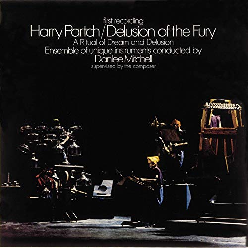 Black album cover featuring musicians with custom instruments in dim lighting.