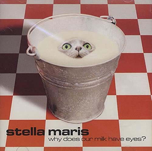 CD cover with a cat's face in a milk-filled metal bucket on a checkered floor.