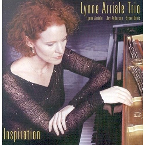 Jazz album cover with a red-haired woman playing piano, wearing a black dress.