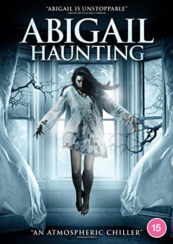 A woman in a white nightgown floats in front of a window in this poster.