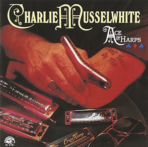 "Album cover with a hand holding a harmonica, surrounded by other harmonicas and sunglasses."