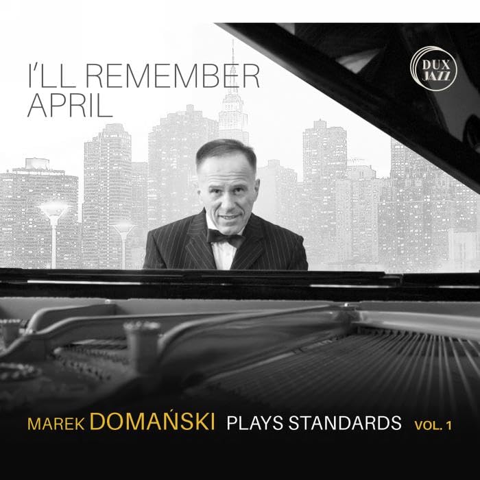 Marek Domanski at a piano with a city skyline backdrop, album cover.