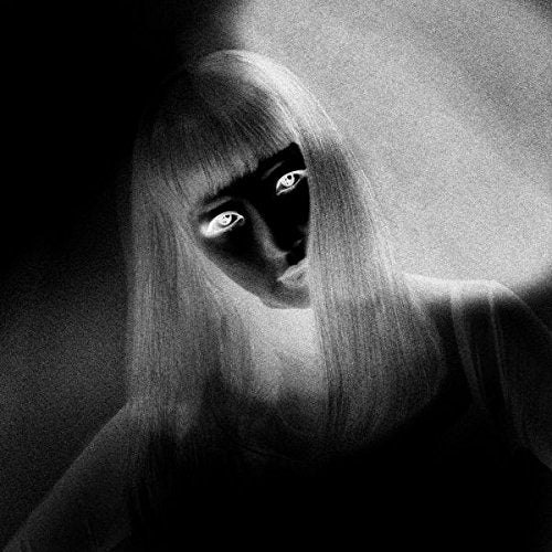 Black and white image of a woman with long hair and shadowed face.