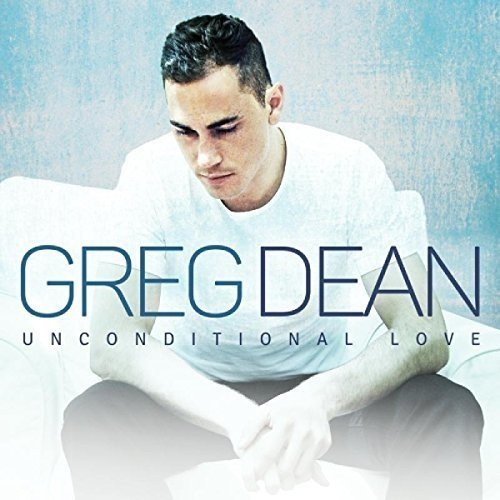 "Album cover with a man sitting on a white couch, looking down."