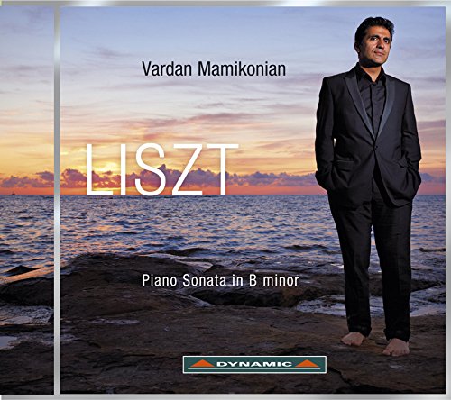 CD cover with man in black suit standing on rocky shore at sunset.