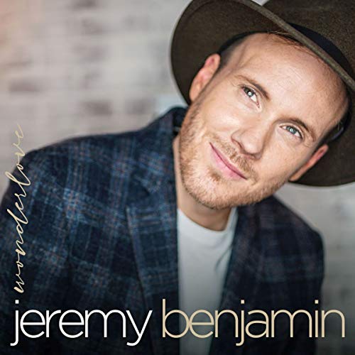 Album cover featuring a man in a hat and plaid jacket, smiling.