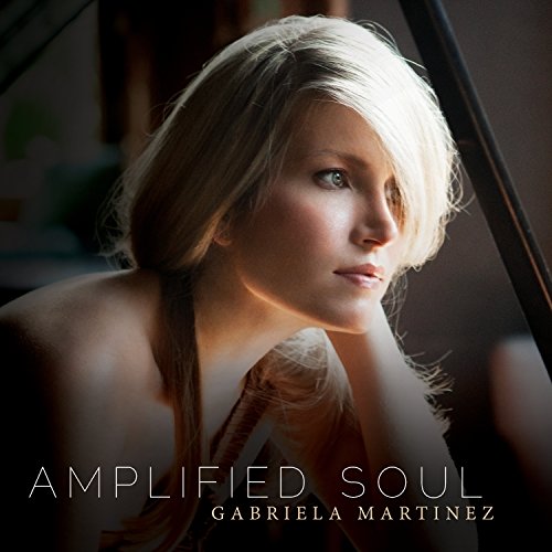 "CD cover featuring a blonde woman resting her head on a piano."