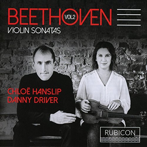 Black and white image of a man and woman holding instruments, with red text overlay.