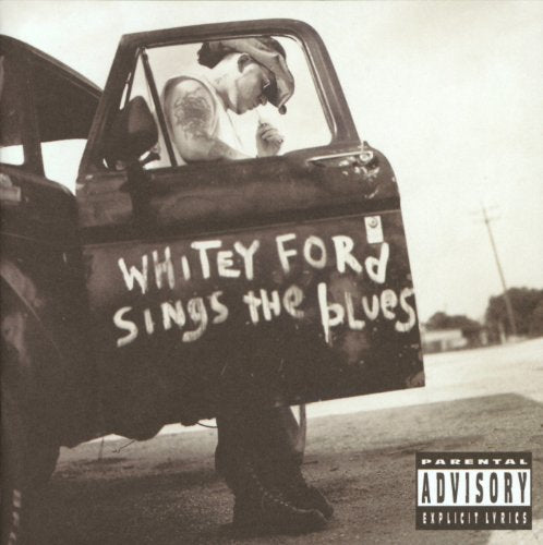 Black and white album cover featuring a man leaning out of a truck.
