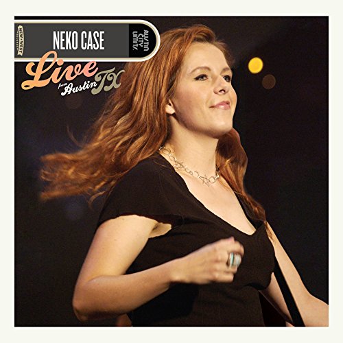 Neko Case album cover featuring a woman with red hair against a dark background.