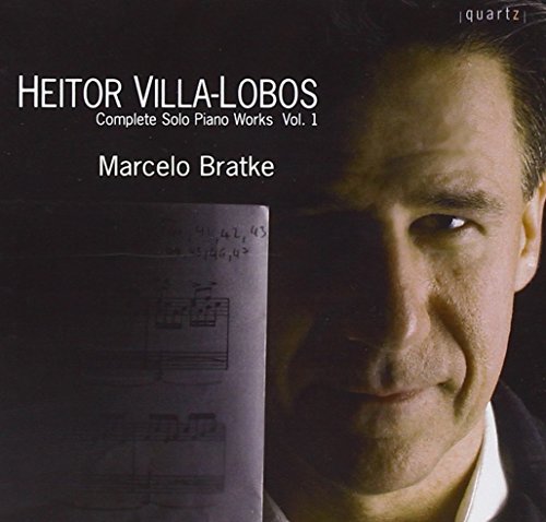 CD album cover with a man and sheet music against a black background.
