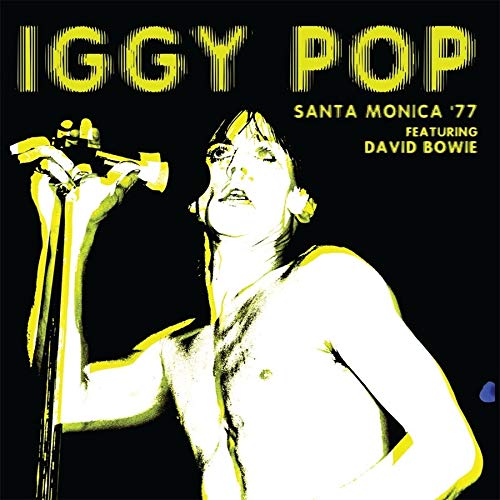 Iggy Pop performing with a microphone, yellow text on black background.