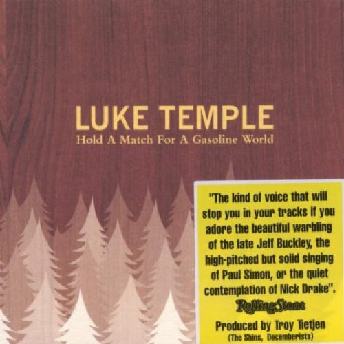 "Album cover with red-brown background, trees, and yellow review quote box."
