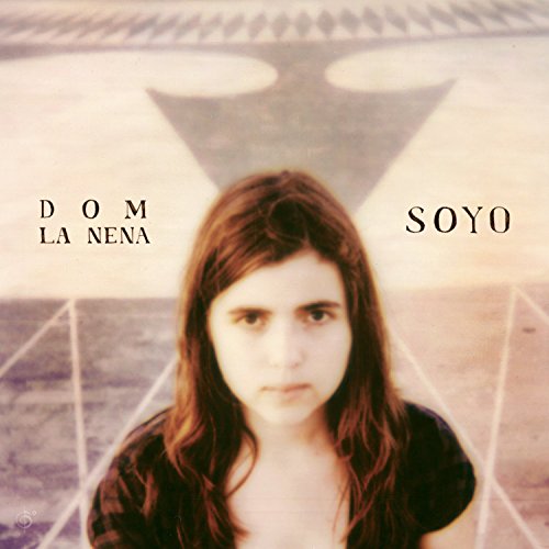 CD album cover with a woman and abstract geometric background, titled "Dom La Nena - Soyo".