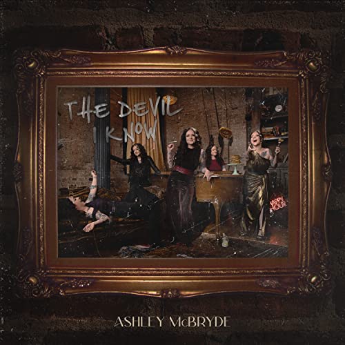 Ashley McBryde album cover, “The Devil I Know,” in an ornate gold frame.