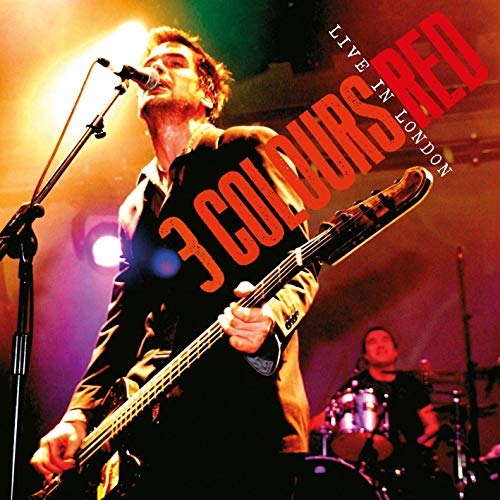 "CD cover featuring a musician singing into a microphone on a lit stage."