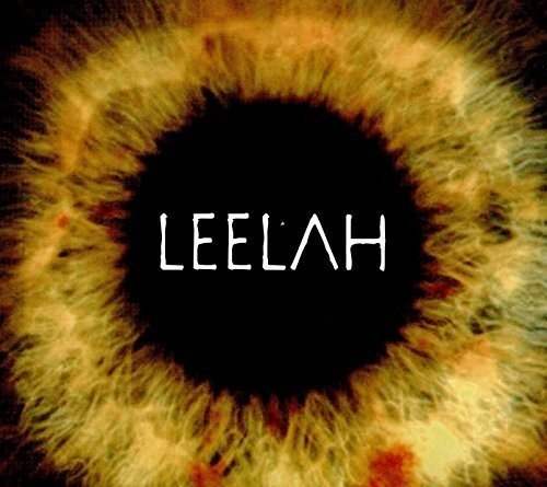 The image depicts a black circle surrounded by a blurry, yellow and red ring. Alt text: "Album cover with 'LEELAH' text on black circle surrounded by yellow ring."