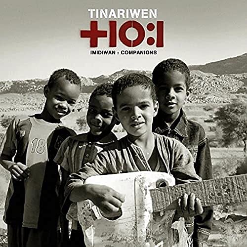 Tinariwen album cover: four young boys with a guitar, desert landscape.