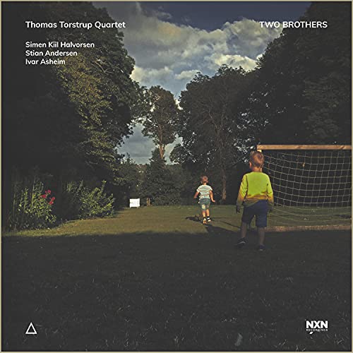 "CD cover with two boys near a soccer goal in a park."