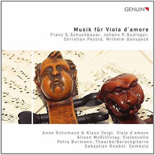 CD cover featuring carved wooden viola d'amore heads on sheet music.