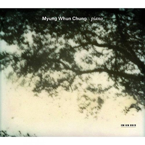 A CD cover with a blurry tree image and white and black text.