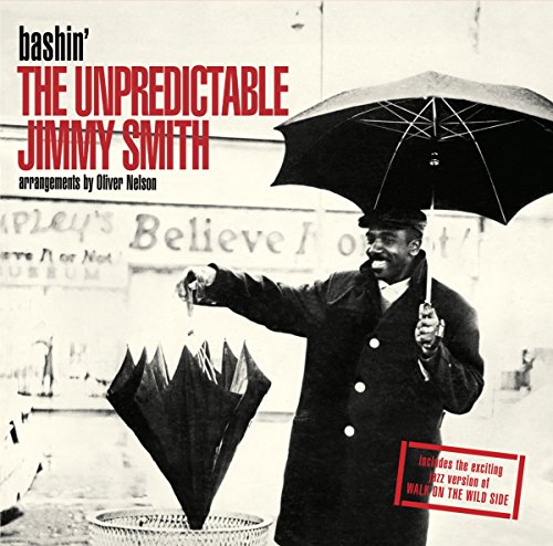 "Album cover with a man holding an umbrella, black and white image with red text."