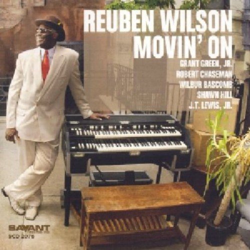 Album cover with man in white suit standing next to an organ.