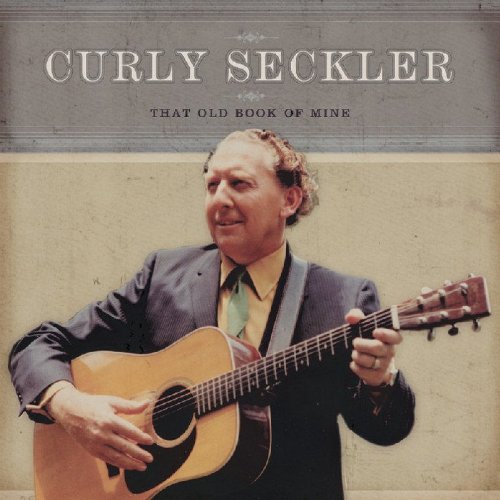 "Album cover with Curly Seckler holding a guitar, wearing a suit."