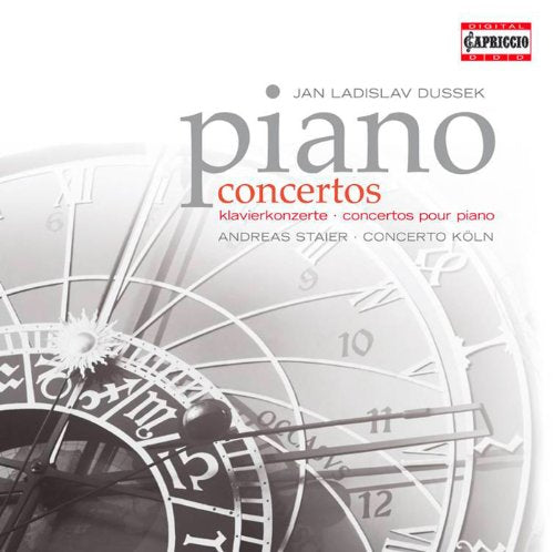 "Album cover featuring a faded clock face with 'piano concertos' text."