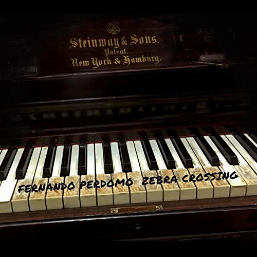 "CD cover featuring a piano keyboard with 'Fernando Perdomo Zebra Crossing' written on the keys."