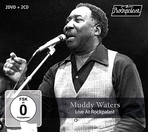 Black and white portrait of Muddy Waters singing into a microphone.