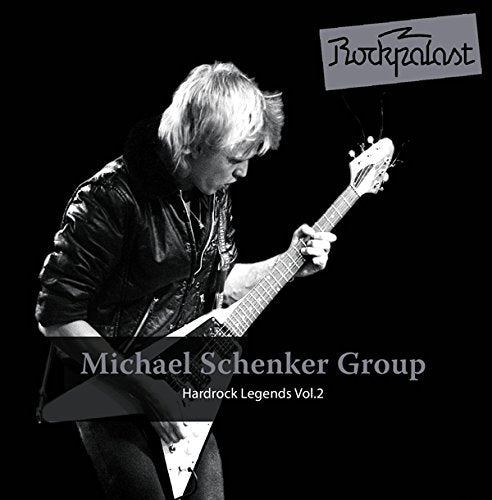 "Album cover featuring a black-and-white photo of a man playing an electric guitar."