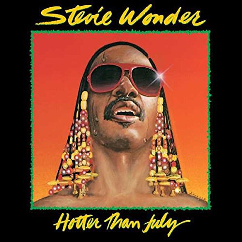 Stevie Wonder's album cover featuring the artist wearing red sunglasses against an orange background.