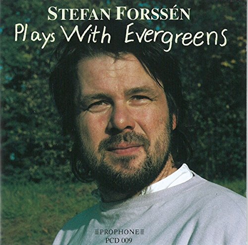 "CD cover with a man having dark hair and beard, outdoors background."