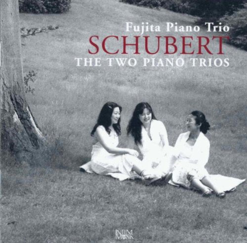 Black and white CD cover with three women sitting in a grassy field.