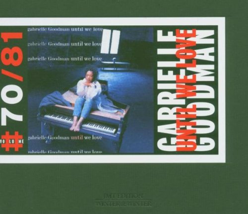 A blurry image of a CD cover featuring a woman sitting on a piano.