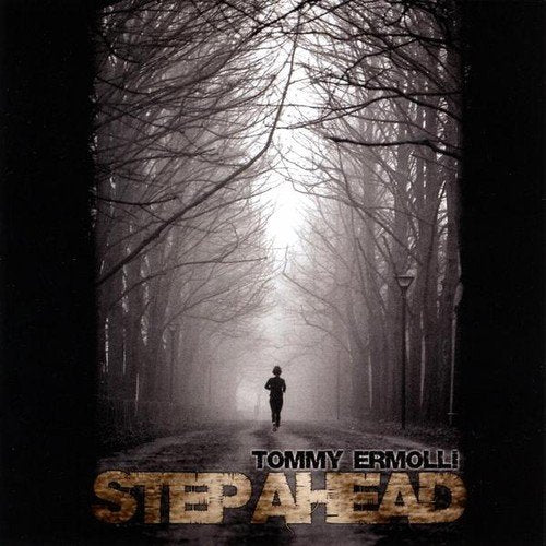 CD cover: lone figure running down a foggy tree-lined path.