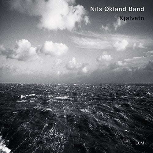 Black and white album cover featuring turbulent water and cloudy sky with text overlays.