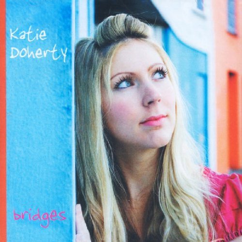 Album cover featuring a blonde woman in a pink top leaning against a blue wall.